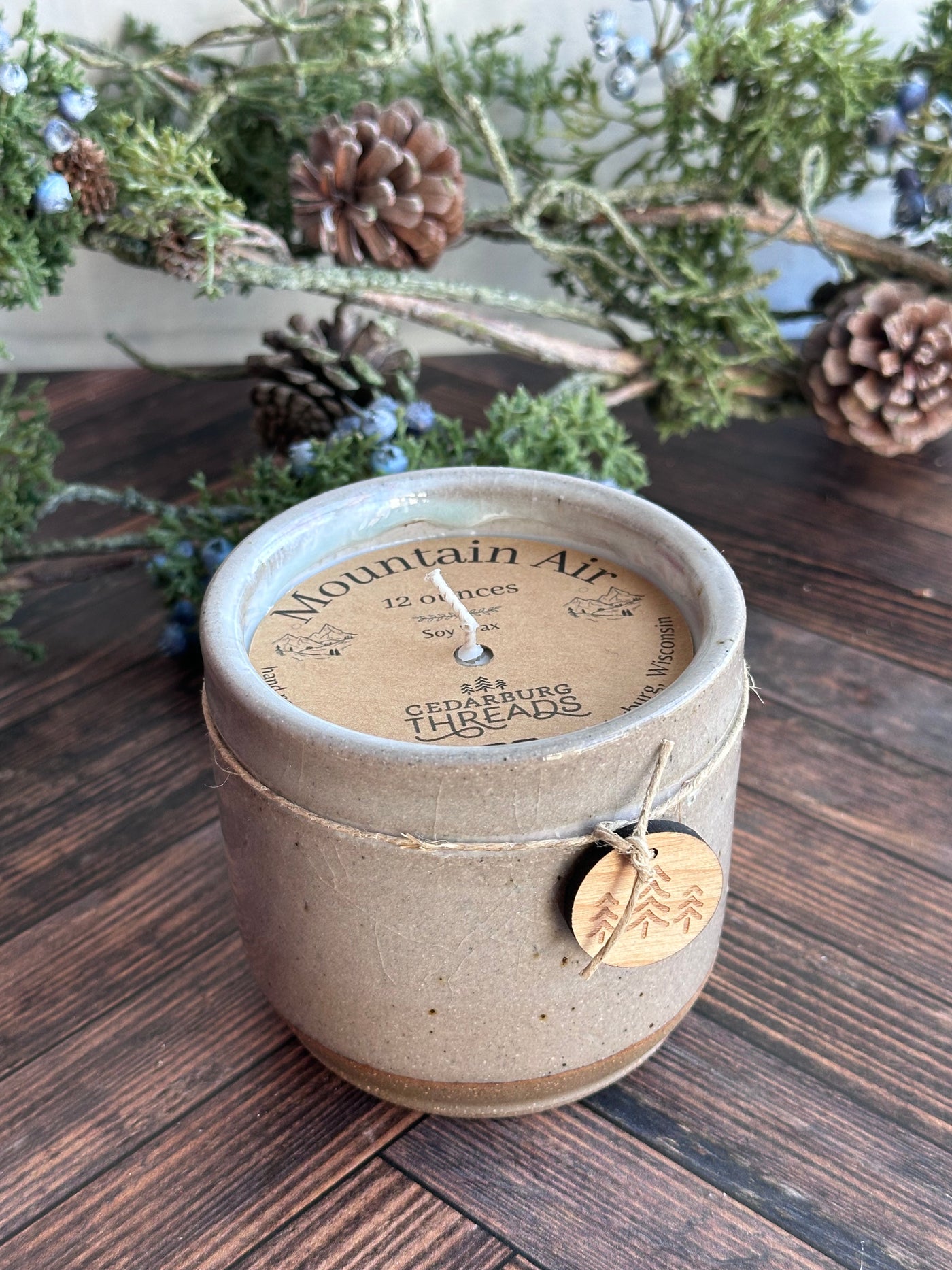 Grey 12 ounce ceramic vessel with mountain air soy candle