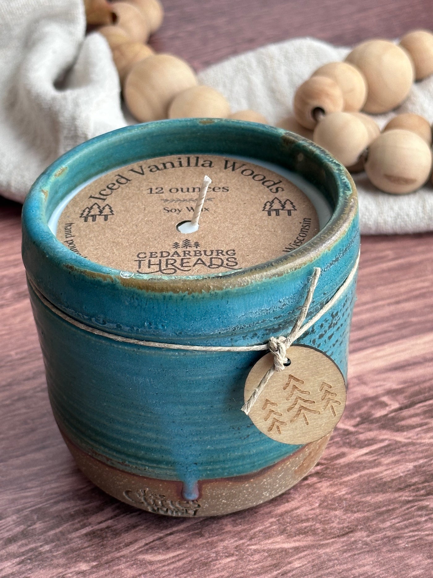 Iced Vanilla Woods hand poured soy candle  in an 12 ounce teal ceramic vessel