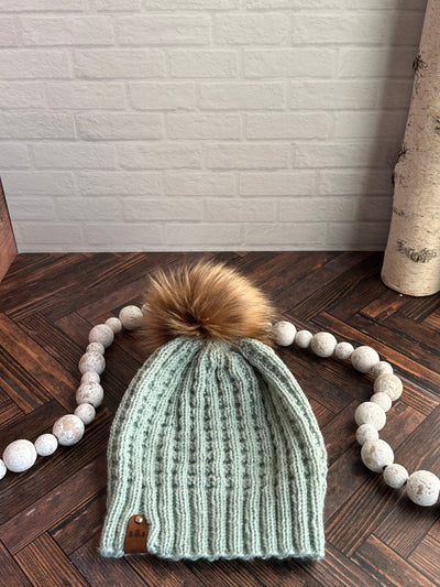 mint green waffle knit hat with brown faux fur pom
