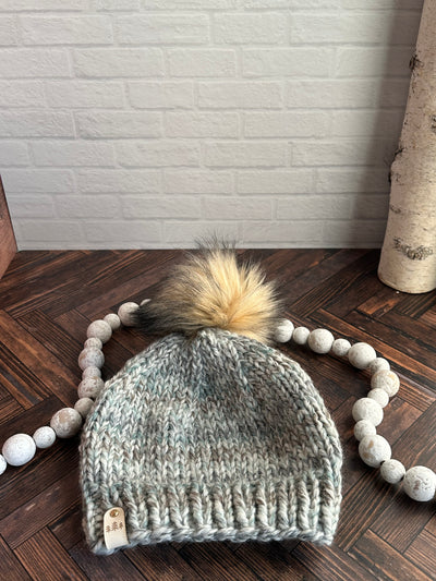 blue marble with light brown faux fur pom knit beanie hat