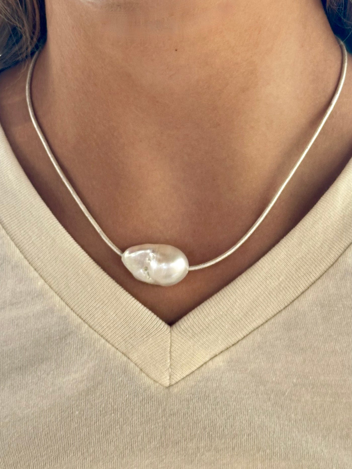 natural pearl on white cord with lobster clasp