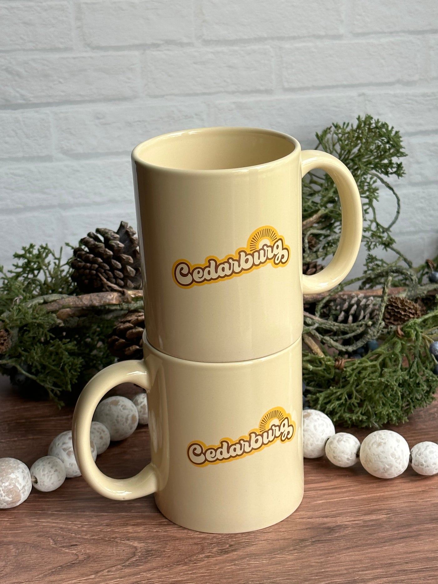 two Cedarburg sun ceramic mugs in light yellow