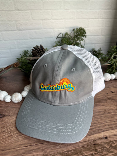 Cedarburg sun retro design in turquoise, yellow and orange on a grey and white trucker hat