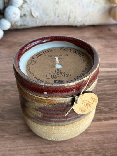 Cactus and sea salt hand poured soy candle in a handmade ceramic vessel in 12 ounces and red color