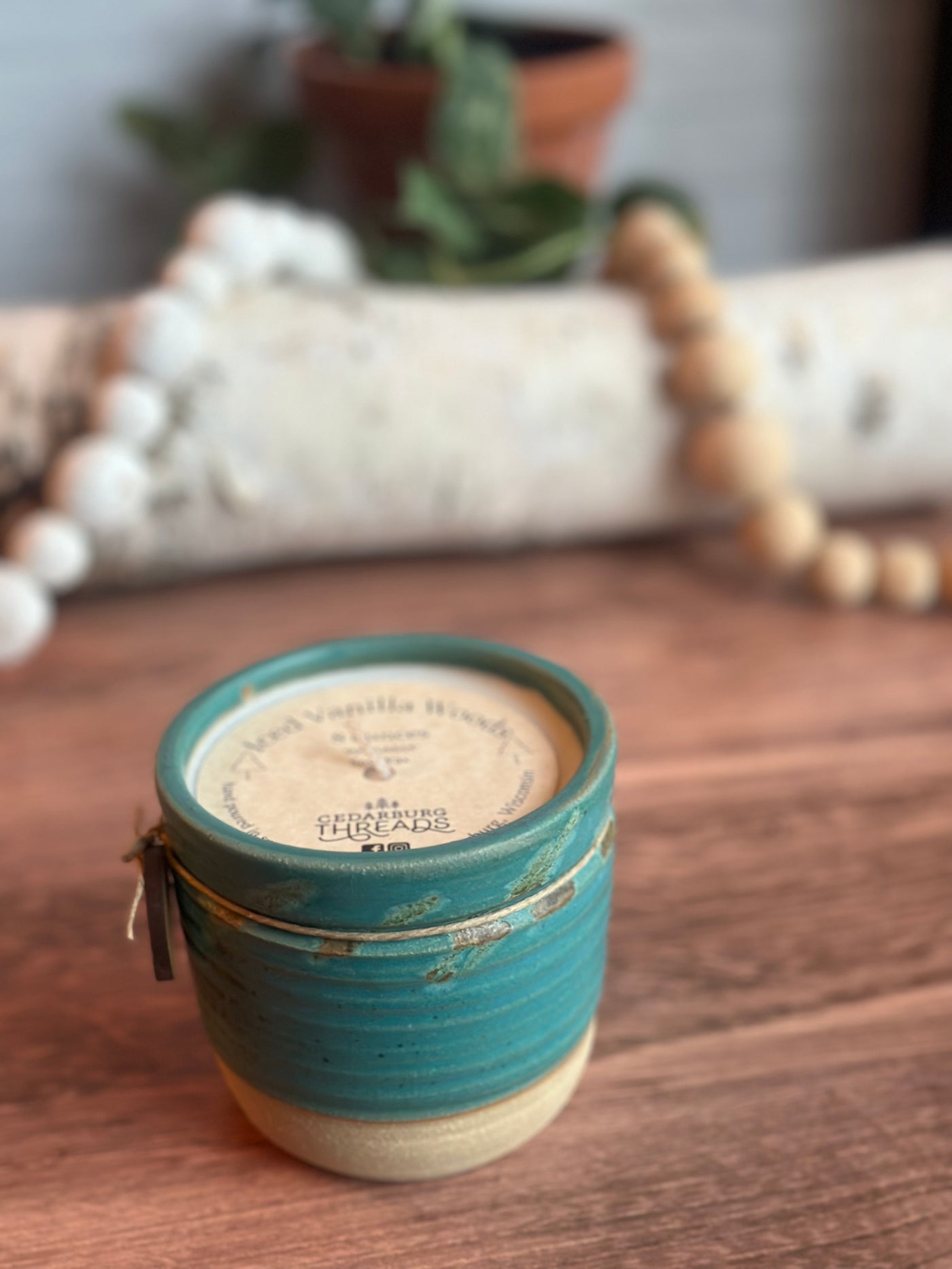 Iced Vanilla Woods hand poured soy candle  in an 8 ounce teal ceramic vessel
