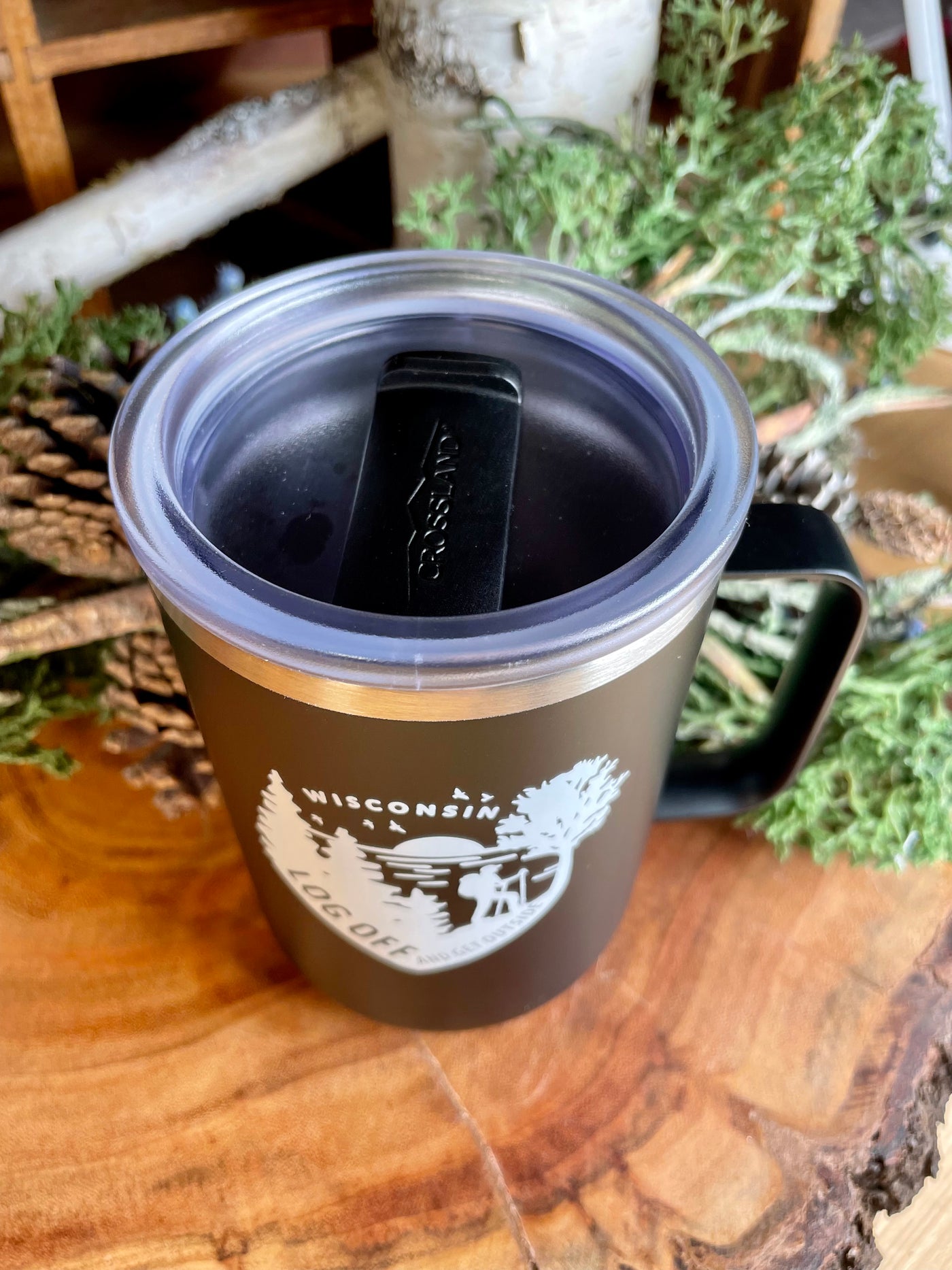 slide top design on insulated black tumbler with white log off Wisconsin design