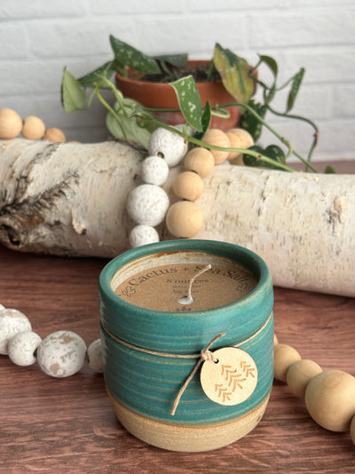 Cactus and sea salt hand poured soy candle in a handmade ceramic vessel in 8 ounces and teal color