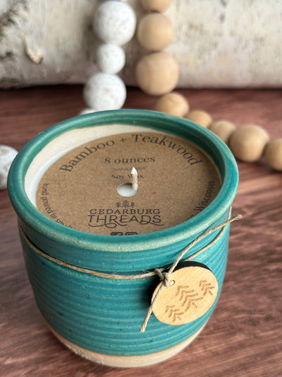 8 oz Bamboo & Teakwood soy candle in teal ceramic vessel