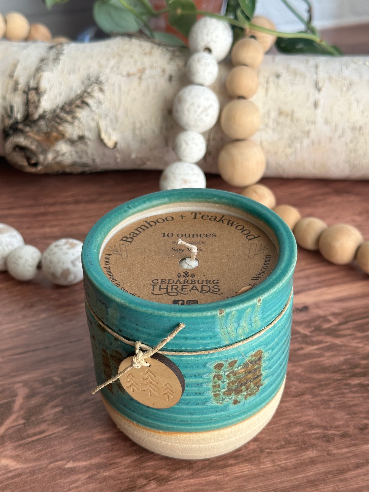 10 oz Bamboo & Teakwood soy candle in teal ceramic vessel