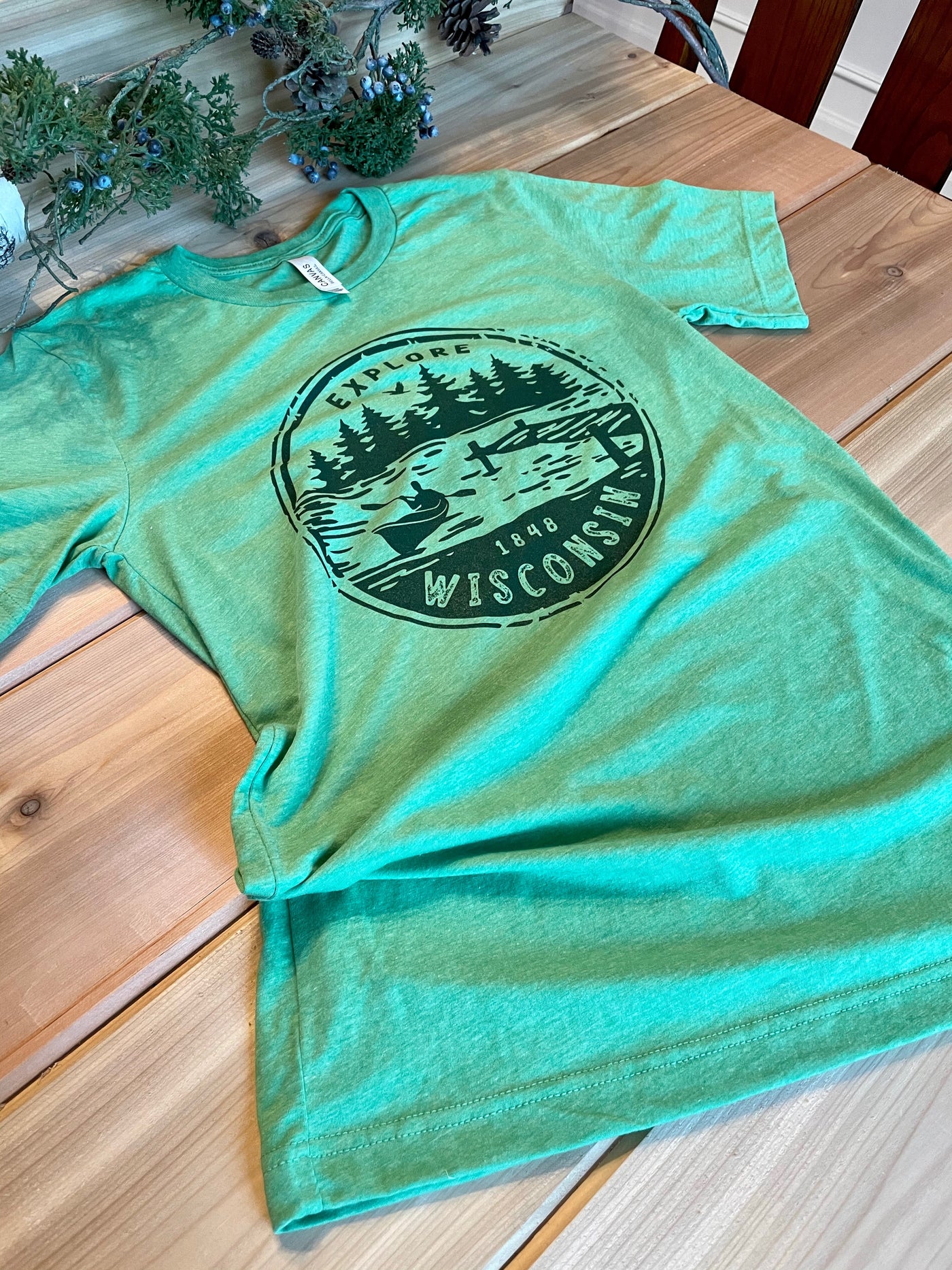 Green triblend short sleeve unisex tee with explore wisconsin paddle design in green