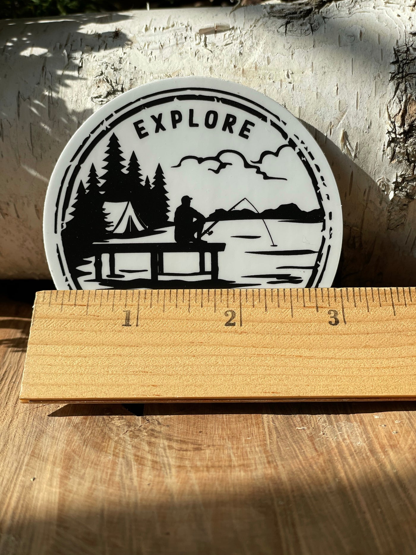 ruler showing the three inch size of the Explore Wisconsin keeper vinyl sticker